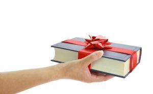 Woman's hand holding a book for gift