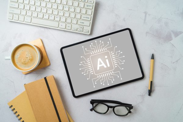 Chat bot and  artificial intelligence technology concept with digital tablet, coffee cup and notebooks. Top view, flat lay